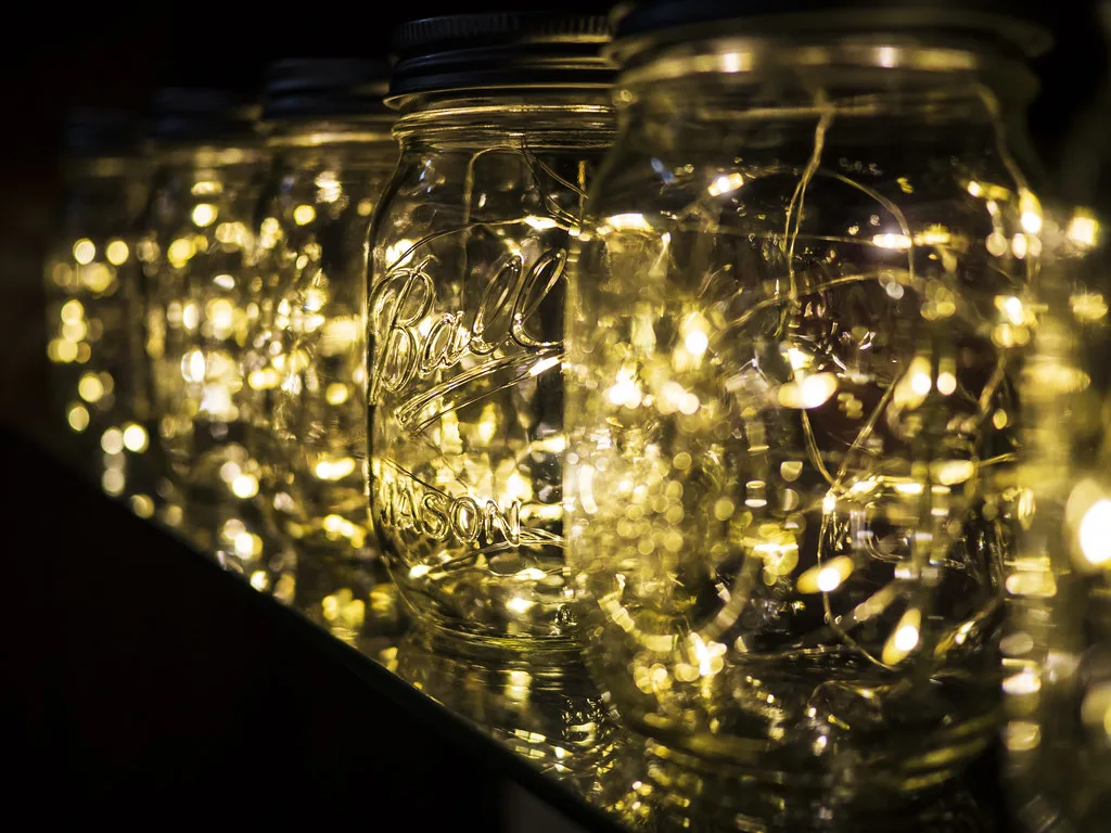 Glass jars filled with glowing warm fairy lights